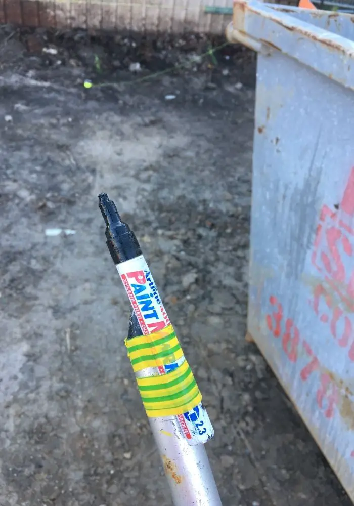 paint pen attached to pole to