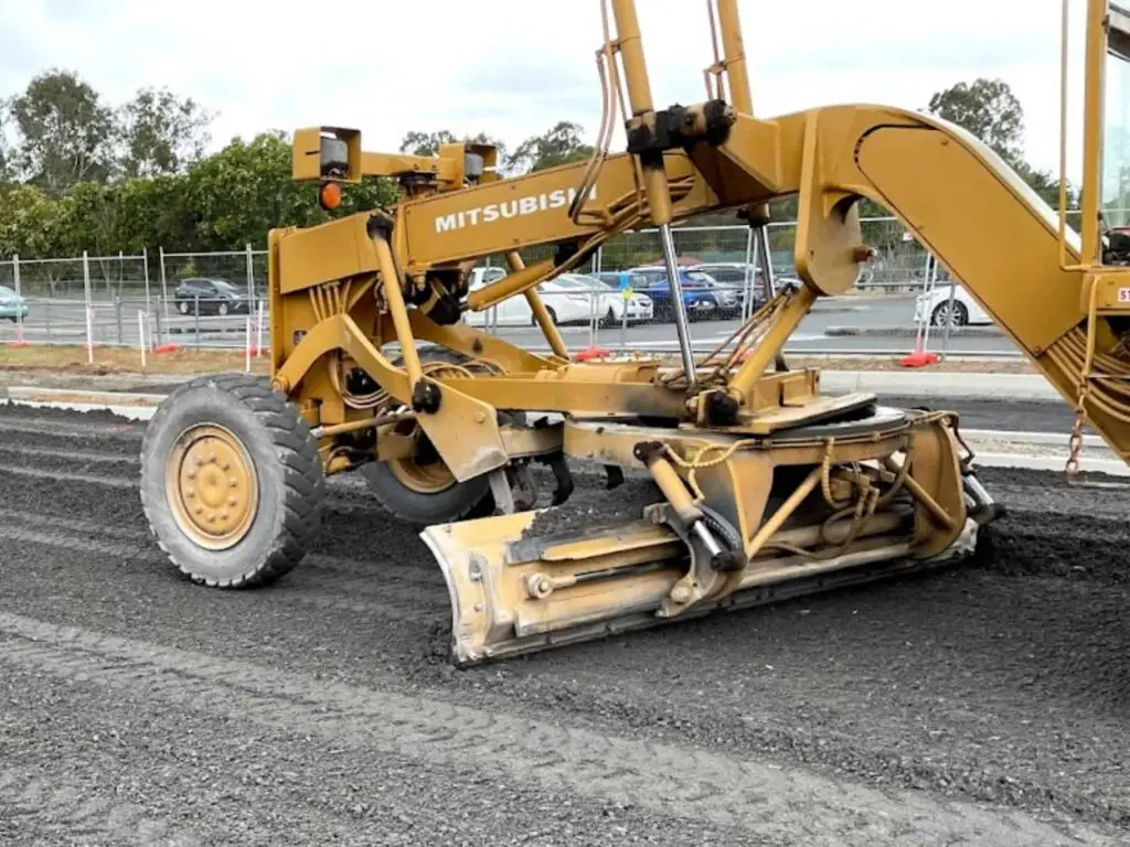 230312 Grader moving road base around car park construction site 1