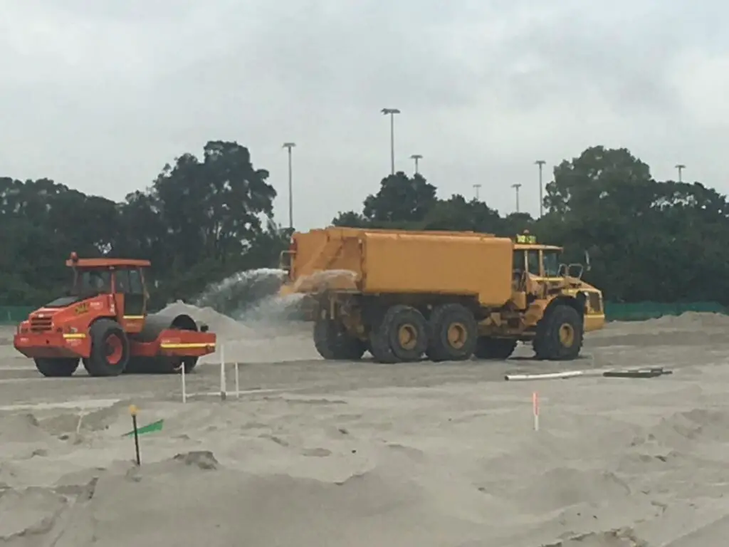 230312 Water truck on site follow by a roller